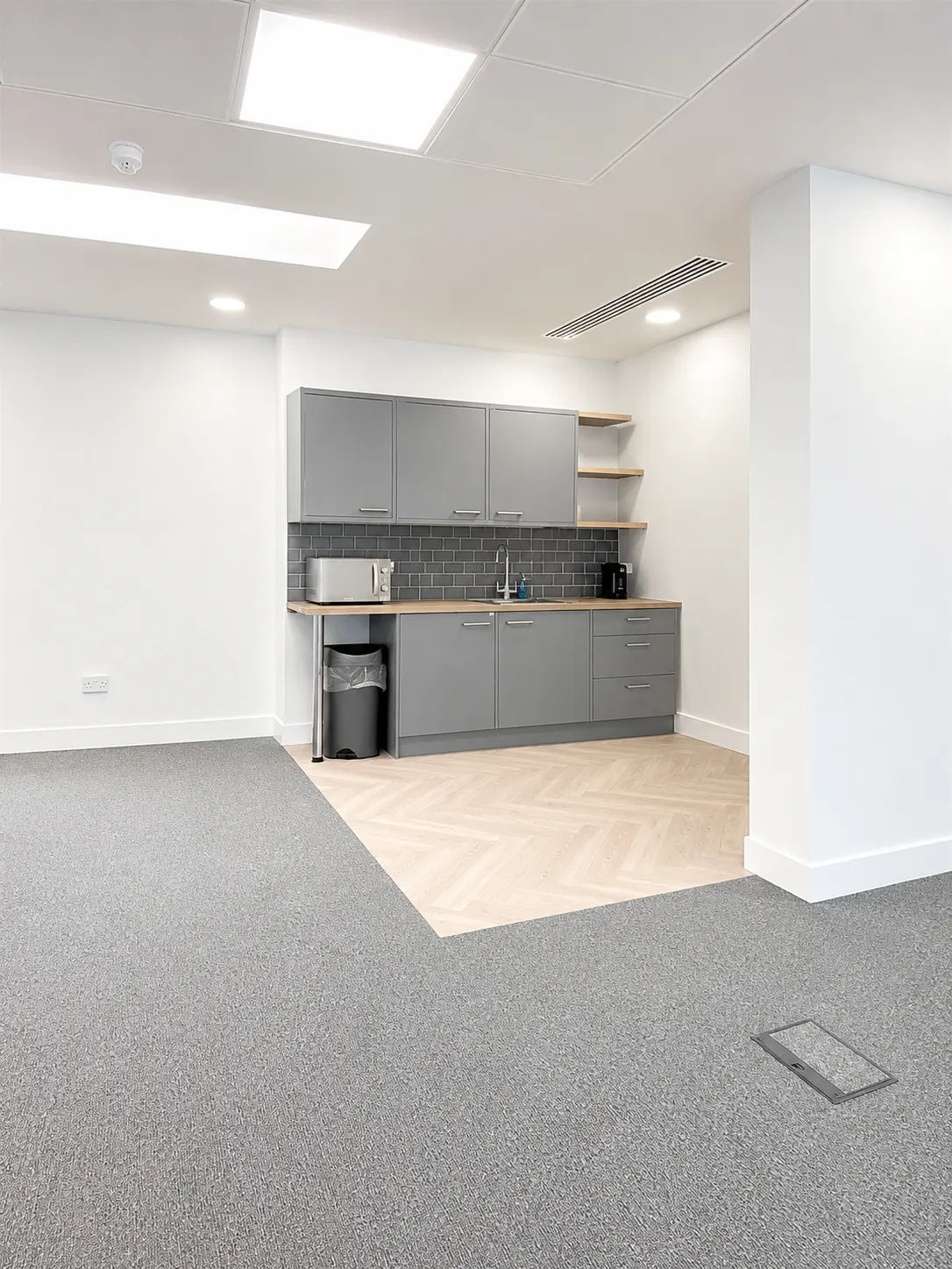 Sixth floor at 16-18 New Bridge Street today, fitted tea point with herringbone floor